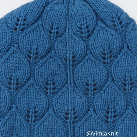 Close-up of blue leaf lace knit hat showing seam detail.