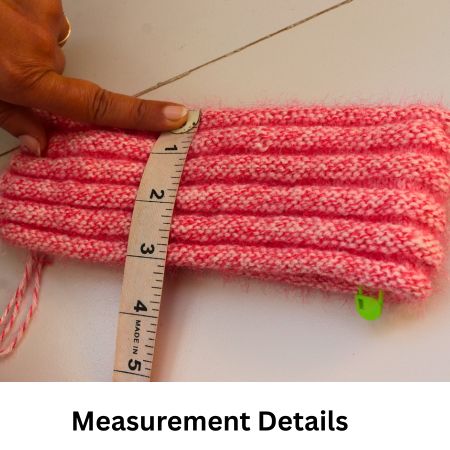 Hand measuring knitted beanie brim using tape measure for accurate beanie sizing.