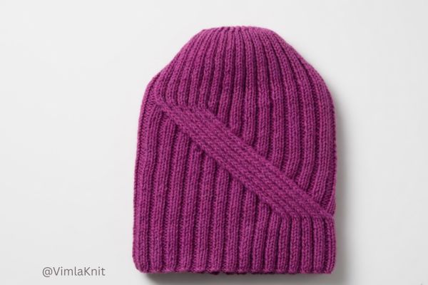 Purple ribbed knit beanie with stylish crossover wrap detail, handmade using easy ribbed knitting pattern for beginners.